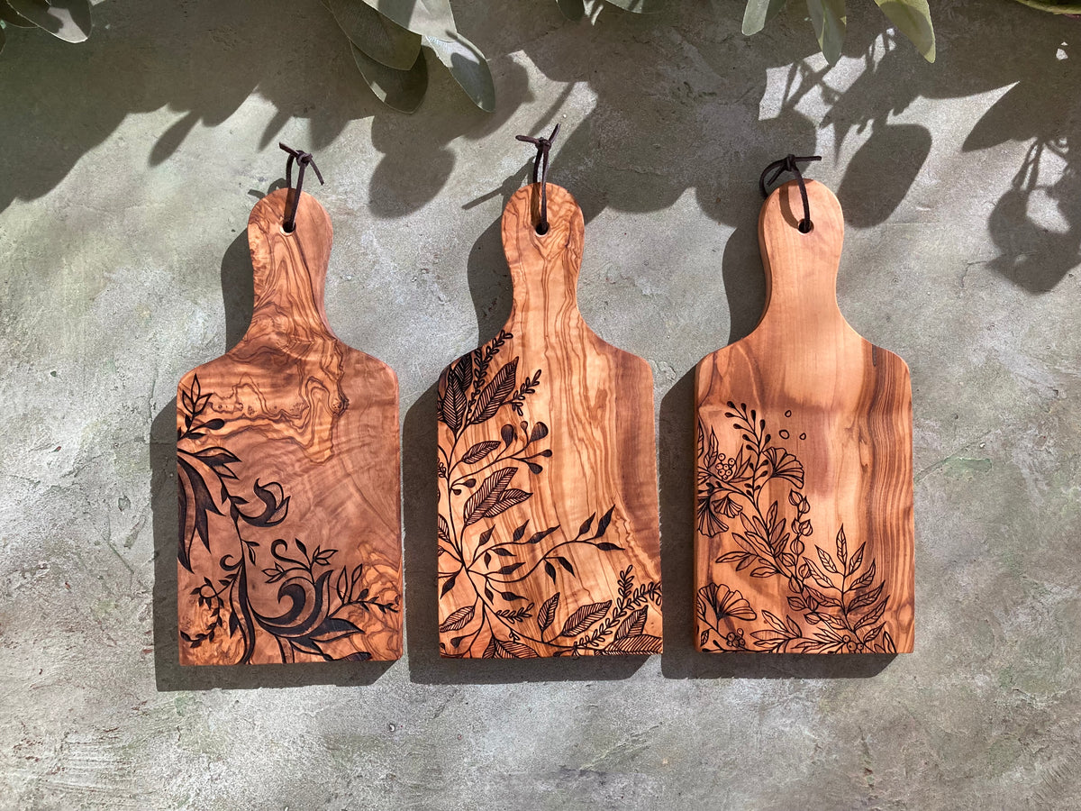Three engraved olive wood padle boards with original designs