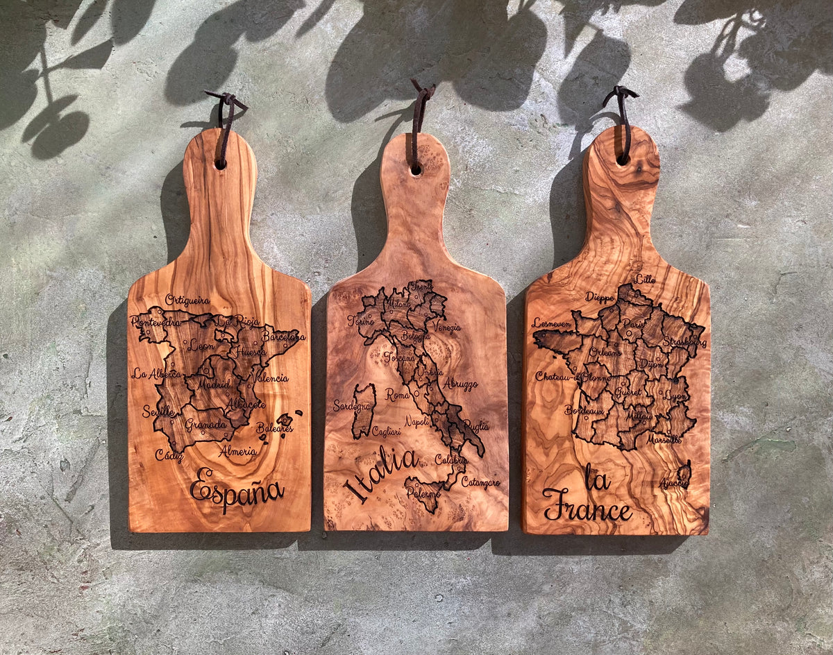 Three wood boards with map designs of Spain, Italy, and France