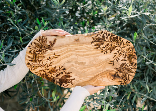 Rustic olive wood serving board engraved with an elegant botanical design