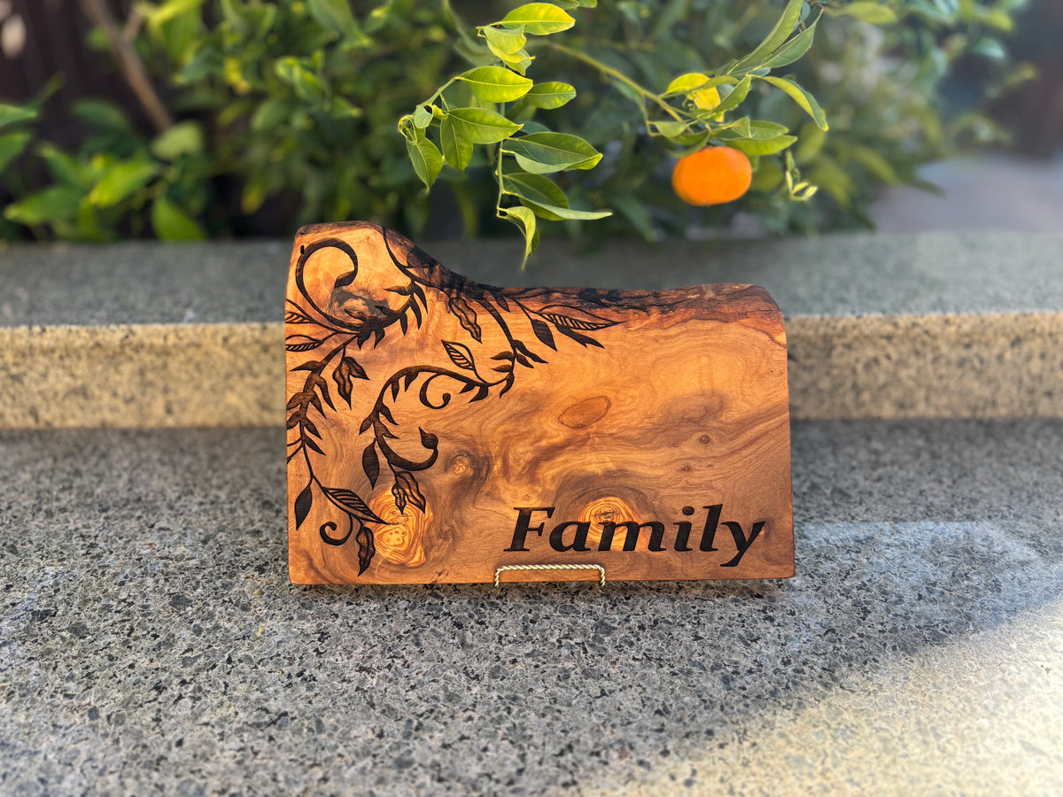 Rustic wood board with a botanical design and Family engraving