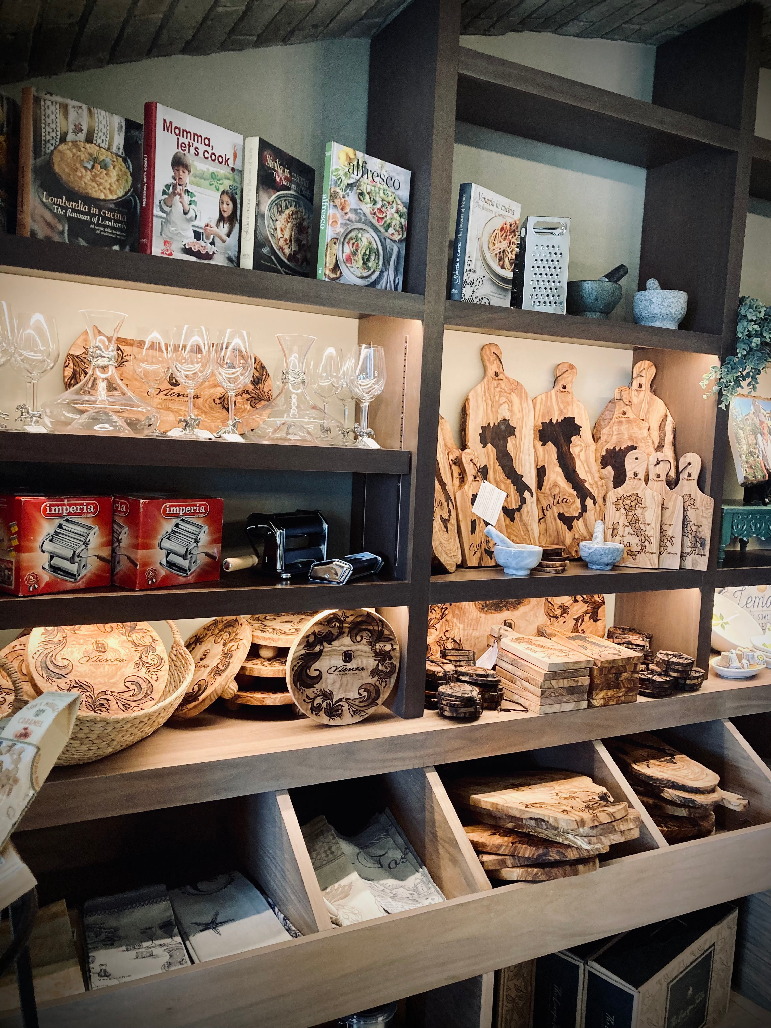 Wooden shelves with decorative items including books, plates, and sculptures.