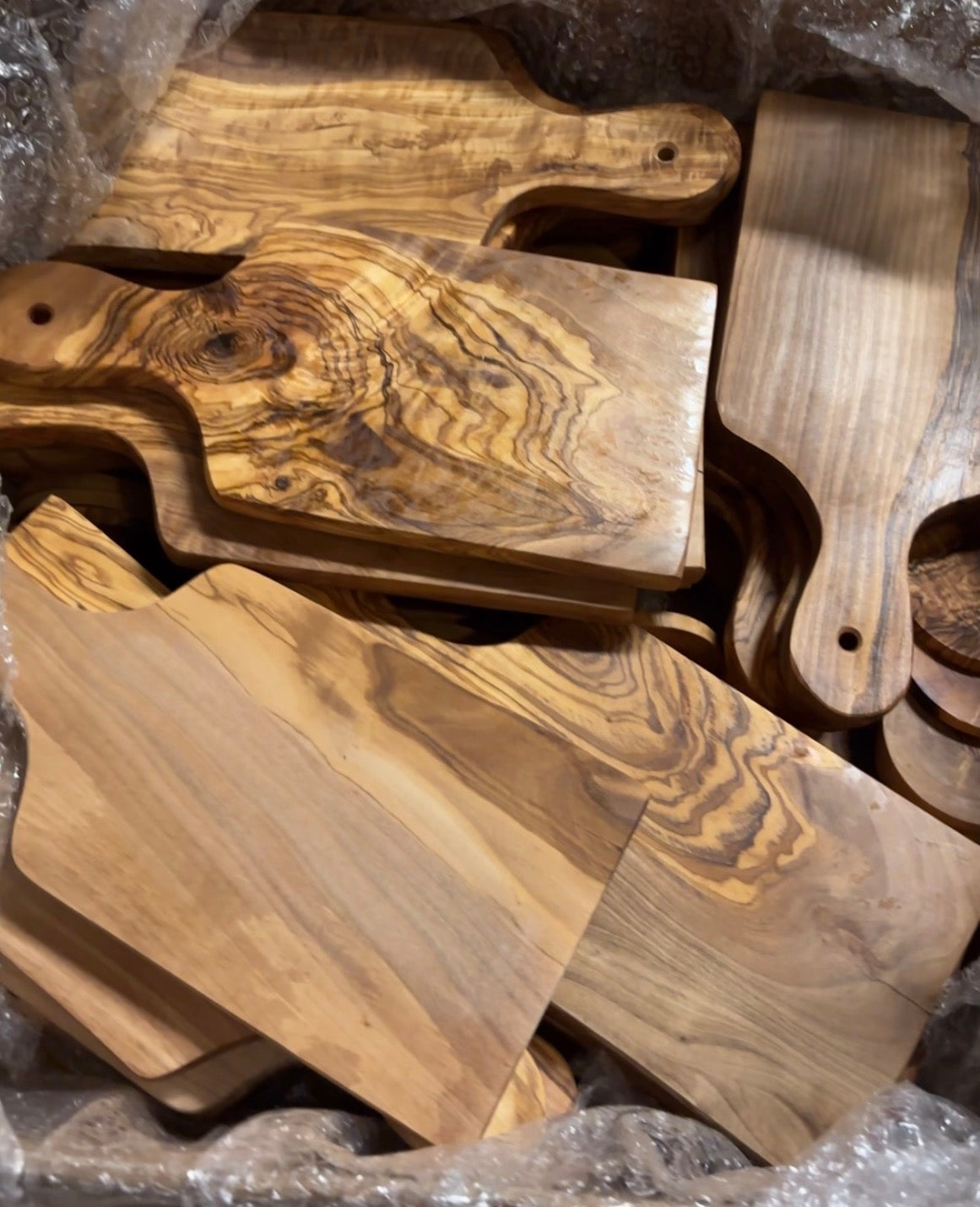 Multiple blank olive wood boards in a workshop